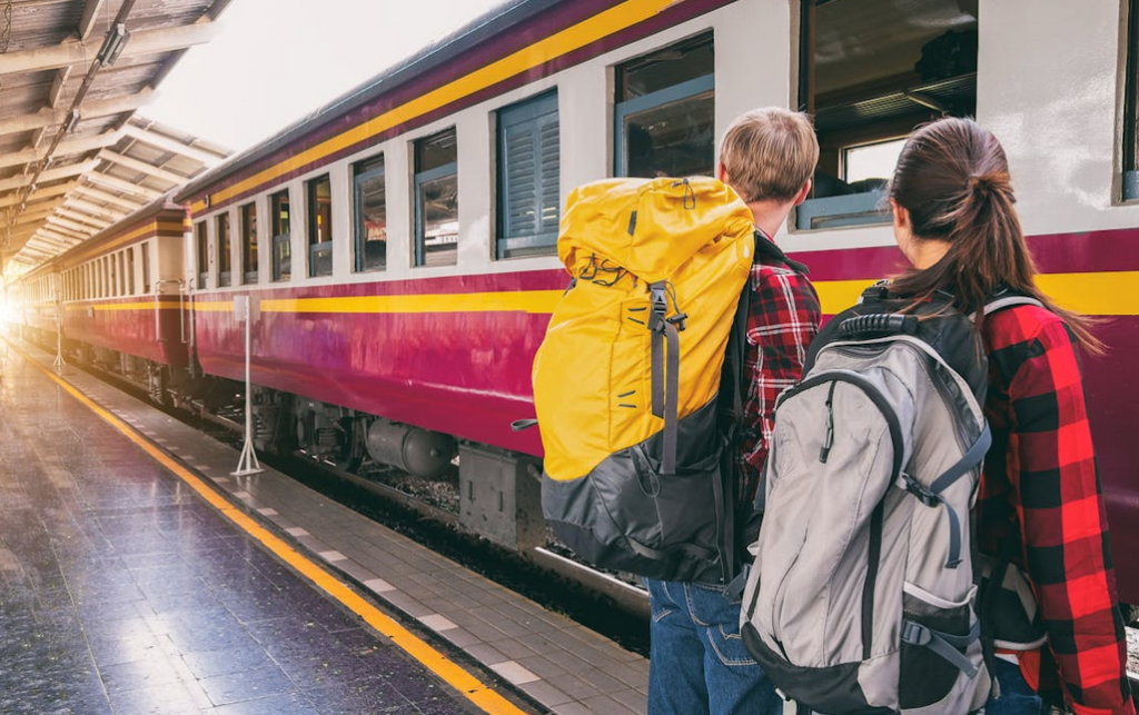two people boarding a train for zero waste travvel